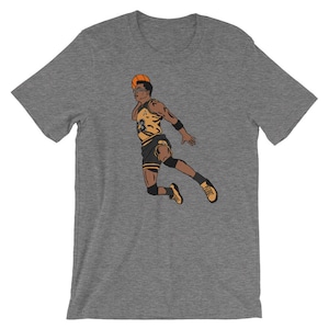 May include: A gray t-shirt with a graphic of a basketball player in a yellow and black uniform, dunking a basketball. The player is wearing a headband and has a determined expression on his face.