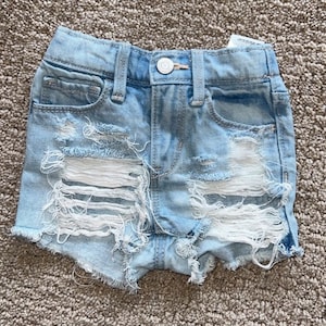 baby girl ripped denim shorts | toddler distressed jean shorts | holey shredded jean cutoff shorts | slashed denim shorts || THE RAYZER