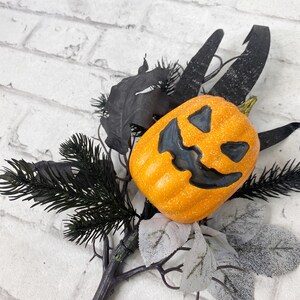 Jack-O- Lantern floral pick with grasses and black twigs