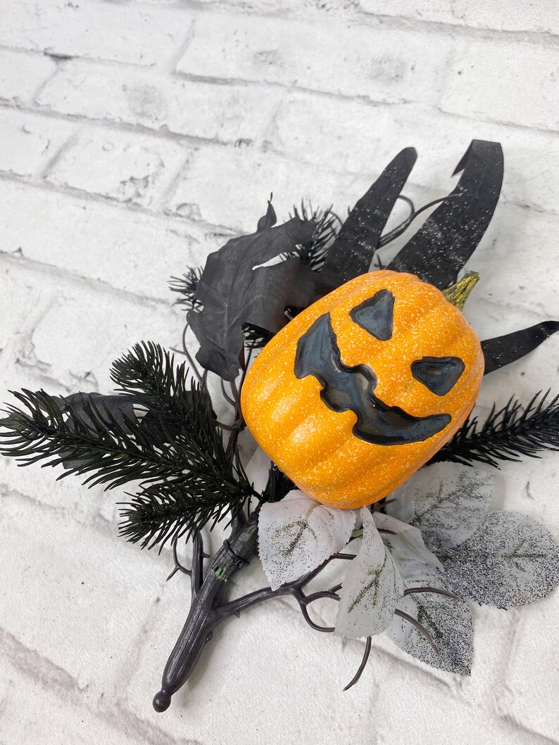 Jack-O- Lantern floral pick with grasses and black twigs