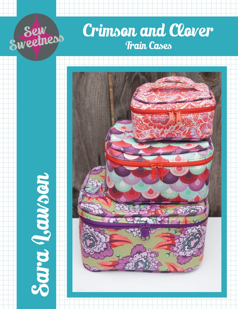 May include: Three stacked train cases with floral and patterned designs. The top case is red with a floral pattern, the middle case has a teal, purple, and red scale pattern, and the bottom case is green with purple flowers. The cases have zippers and handles.