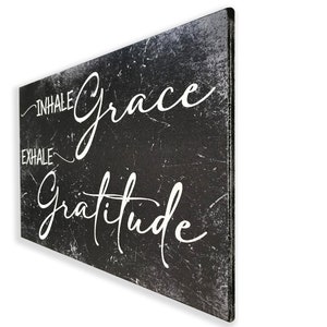 May include: Black and white canvas wall art with a distressed background. The text reads "Inhale Grace Exhale Gratitude".
