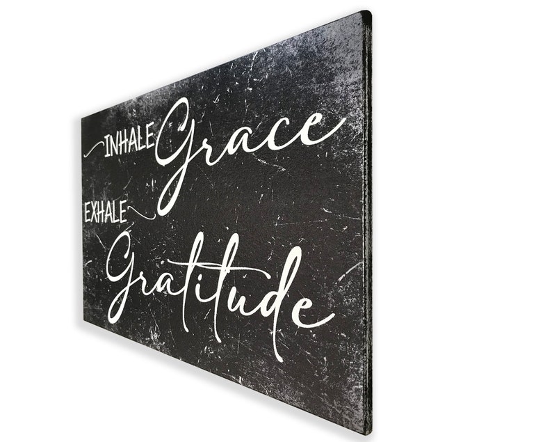 May include: Black and white canvas wall art with a distressed background. The text reads "Inhale Grace Exhale Gratitude".