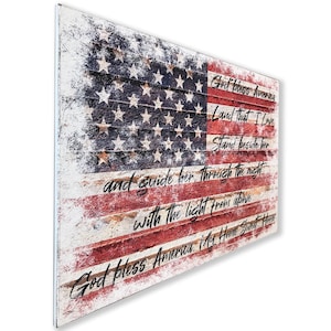 May include: A distressed wood sign with a faded American flag design and the lyrics to the patriotic song "God Bless America".