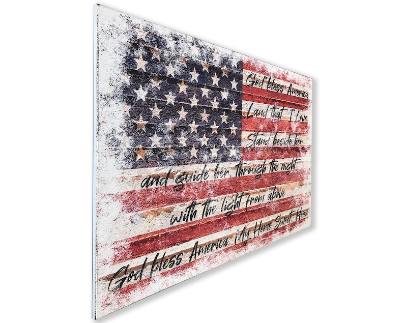 May include: A distressed wood sign with a faded American flag design and the lyrics to the patriotic song "God Bless America".