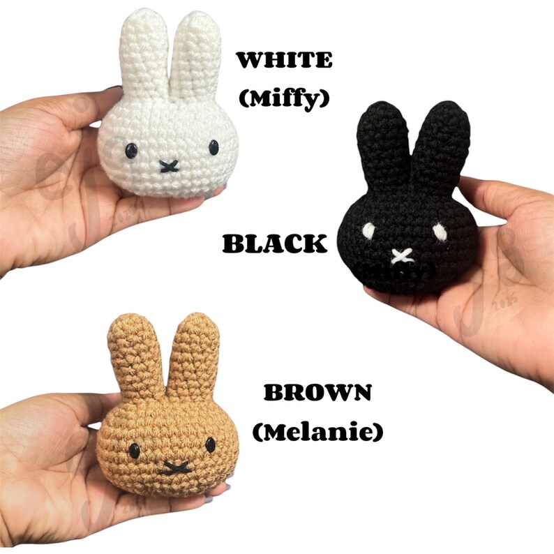 May include: Three small crocheted rabbit heads in white, black, and brown. The white rabbit is labelled WHITE (Miffy), the black rabbit is labelled BLACK, and the brown rabbit is labelled BROWN (Melanie). Each has two upright ears and a simple face.