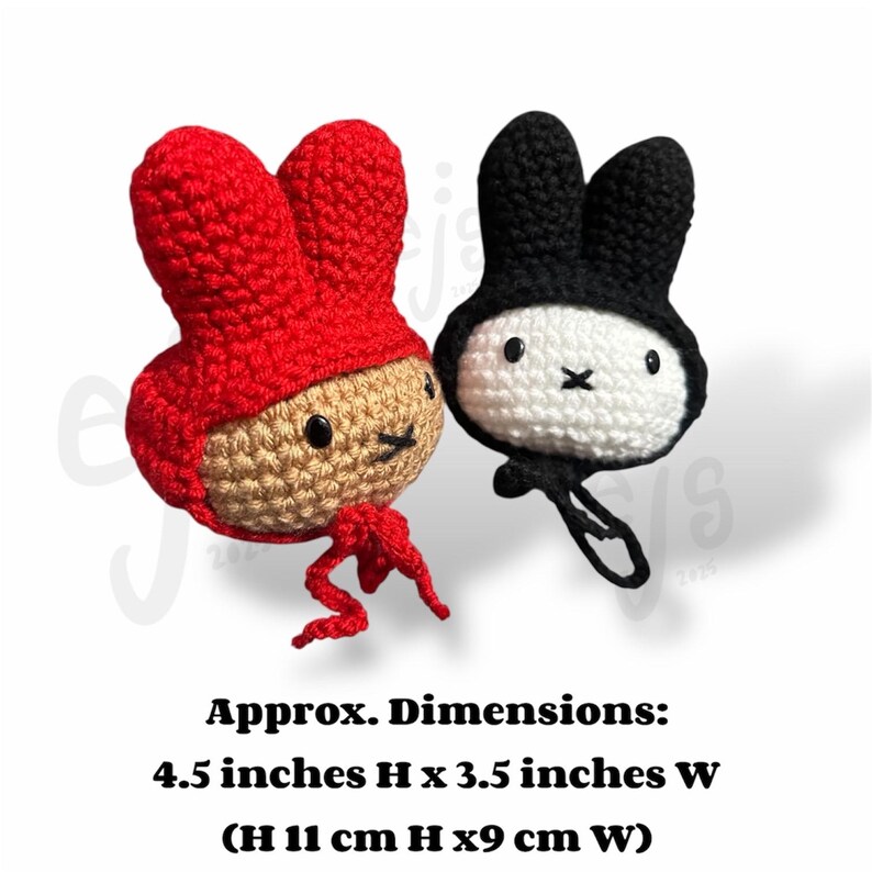 May include: Two crocheted plush figures with rabbit-like ears. One is tan with a red hood and ties, the other is white with a black hood and a small black loop. Text states dimensions are 4.5 inches H by 3.5 inches W, or 11 cm H by 9 cm W.