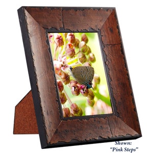 May include: A rustic brown wood picture frame with a distressed finish. The frame is standing upright on a table and features a photo of a butterfly on a flower. The photo is titled "Pink Steps".