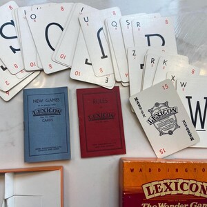 May include: A vintage game of Lexicon, The Wonder Game, by Waddington's. The box is orange with black text. The game includes a set of letter tiles, rules, and a booklet of new games.