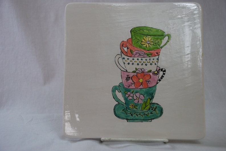 Colorful teacups hand painted on a heavy trivet Food safe.