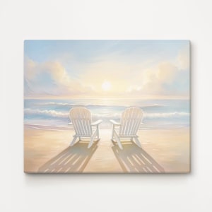 May include: A canvas print of a beach scene with two white Adirondack chairs on the sand. The chairs cast long shadows towards the viewer. The background shows a calm ocean under a pastel sky with a setting sun, evoking a sense of peace.