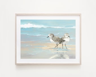 May include: A painting of two sandpipers standing on a sandy beach with blue water and white waves in the background.