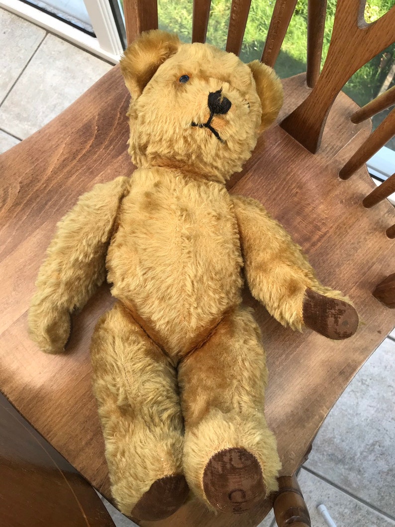 vintage teddy bear with bell in ear
