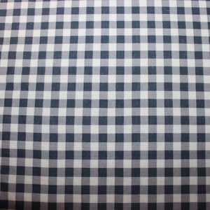 May include: A white and dark blue gingham fabric with a checkered pattern.