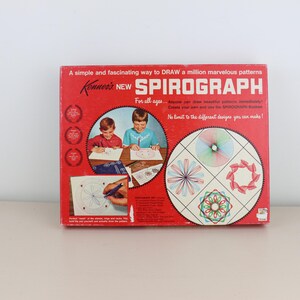 May include: A vintage Spirograph drawing toy box. The red box features the text "Spirograph" and "A simple and fascinating way to DRAW a million marvelous patterns." The box also shows children drawing with the toy and examples of the designs.