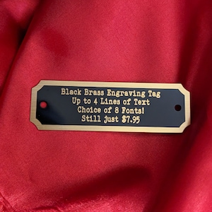 Engraved Tag, Black Brass Notched Corners with Gold Border and Gold Lettering 2.75&quot; x 7/8&quot; with 2 holes. Up to 4 lines of text!