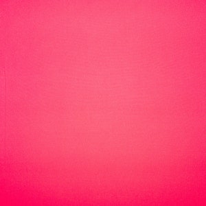 May include: A solid, bright pink background.