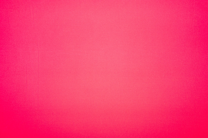 May include: A solid, bright pink background.