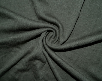 May include: Close-up of a dark gray fabric with a textured surface. The fabric is folded and draped, creating a soft and flowing look.
