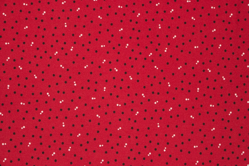Puede incluir: Tela roja con un patr&oacute;n repetitivo de peque&ntilde;os puntos negros y blancos.