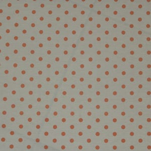May include: A white fabric with a repeating pattern of small orange polka dots.