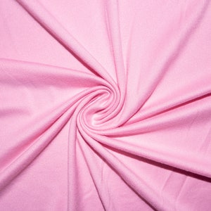 May include: A close-up of a soft, pink fabric with a swirling pattern. The fabric is smooth and has a subtle sheen.