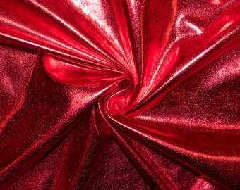 May include: Red metallic fabric with a swirling pattern. The fabric is shiny and has a textured surface.