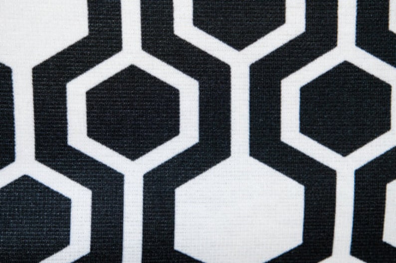 May include: Black and white geometric pattern with a honeycomb design. The pattern is made up of repeating hexagons.