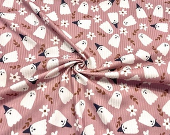 May include: Pink fabric with a white ghost pattern and small white flowers. The ghosts are wearing witch hats.