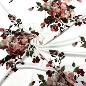 May include: White fabric with a floral print featuring pink and burgundy flowers with green leaves.