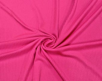 May include: Bright pink ribbed knit fabric with vertical lines. The fabric is gathered in a spiral, creating a textured pattern. The material has a soft, flowing appearance, ideal for clothing or home decor projects.