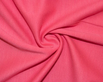 May include: Close-up of a soft, pink fabric with a textured surface. The fabric is folded and draped, creating a smooth, flowing look.