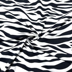 May include: Black and white zebra print fabric. The fabric is soft and stretchy, making it perfect for a variety of sewing projects.