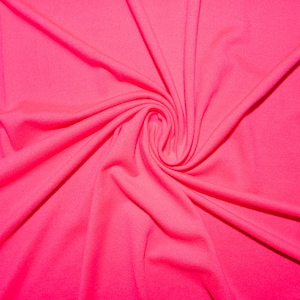 May include: A close-up of a bright pink fabric with a swirling pattern. The fabric is smooth and soft, with a slight sheen.