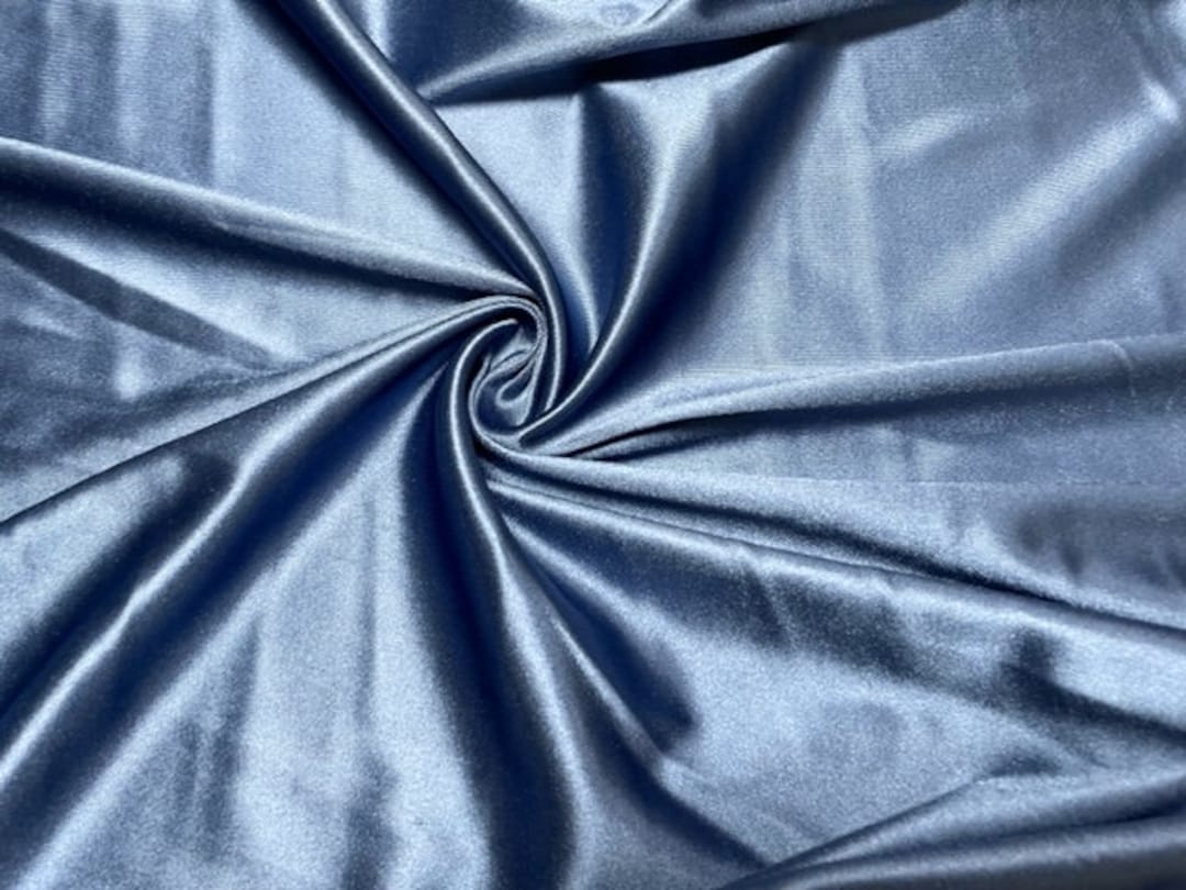 Light blue wavy background from a textile material Fabric with fold  texture closeup Creased shiny denim cloth Stock Photo  Alamy