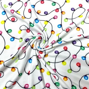 May include: White fabric with a repeating pattern of colorful light bulbs connected by black wires. The light bulbs are in various colors, including red, yellow, green, blue, and purple.