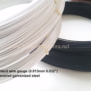 May include: Two spools of wire, one silver and one black, are shown. The silver wire is tightly wound, and the black wire is next to it. Text on the image reads: 21 Standard wire gauge (0.813mm 0.032") rayon covered galvanized steel.