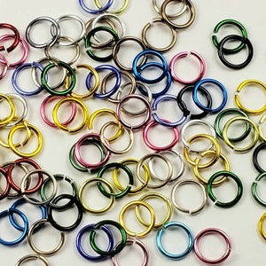 May include: Assortment of colorful metal jump rings in various sizes. The jump rings are made of metal and are perfect for jewelry making, crafting, and other DIY projects.