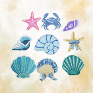 May include: A collection of nine embroidered patches featuring various sea life and shells. The set includes a pink starfish, a blue crab, a purple conch shell, a blue nautilus, a yellow starfish with a blue bow, and several teal and blue seashells.