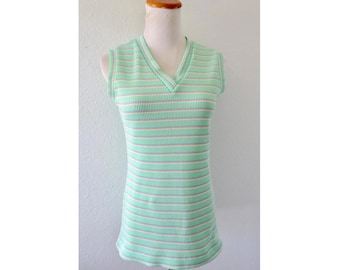 May include: A sleeveless ribbed knit top featuring a V-neckline and a horizontal striped pattern in alternating shades of mint green, white, and thin pink lines. The garment is displayed on a mannequin and has a fitted silhouette throughout.