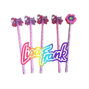 May include: A collection of Lisa Frank pencils. Four pencils have sheep-shaped erasers, and one has a flower-shaped eraser. The pencils are pink with a colorful pattern. The Lisa Frank logo is in the center.