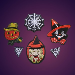 May include: Set of six Halloween-themed iron-on patches. The patches feature a jack-o'-lantern, a witch, a black cat, and three spiderwebs.