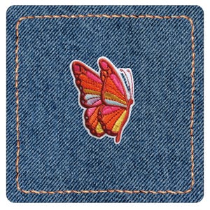 May include: A square denim patch with rounded corners and orange stitching along the border. Centered on the blue fabric is an embroidered butterfly featuring vibrant shades of orange, pink, yellow, and light blue with a white outline.