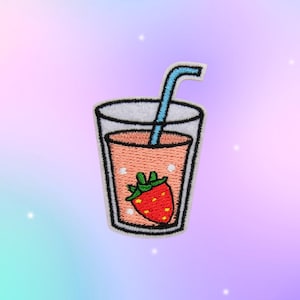 May include: An embroidered patch featuring a glass filled with a light orange liquid, a bright red strawberry with green leaves, and a blue straw. The design is outlined in black thread with a white border, creating a clear, graphic representation.