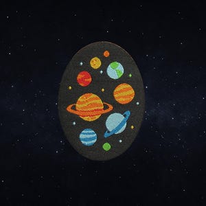 May include: A dark gray oval patch featuring a colorful embroidered solar system design. Planets in shades of orange, blue, green, and yellow are arranged on the patch, with a starry background.