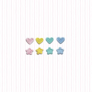 May include: A collection of embroidered patches in pastel colors, including hearts and stars. The patches are in pink, yellow, teal, and blue, arranged in two rows against a white background with pink vertical stripes.