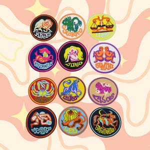 May include: A collection of twelve embroidered patches, each featuring a different zodiac sign. The patches are circular with colorful designs and text, including Aries, Scorpio, Libra, Capricorn, Virgo, Gemini, Cancer, Taurus, Pisces, Aquarius, Leo, and Sagittarius.