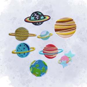 May include: Embroidered patches featuring colorful planets and stars. Designs include planets with rings in shades of yellow, blue, red, and green. The patches are on a white background, perfect for adding to clothing or accessories.
