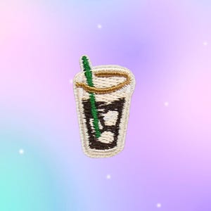 May include: An embroidered patch shaped like a clear glass filled with a dark brown liquid and ice cubes. The glass features a gold-colored rim and a bright green straw extending from the top. The embroidery uses white, brown, gold, and green thread.