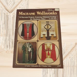 May include: A brown softcover craft book titled Macrame Wallworks by Otti Miles. The cover features four circular and rectangular photographs displaying various macrame wall hangings in red, white, green, and brown tones with fringe details.